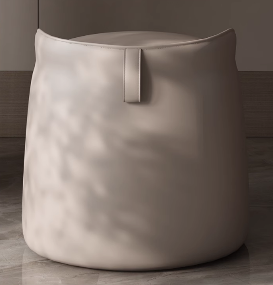 Beige pouf with a handle on a wooden floor