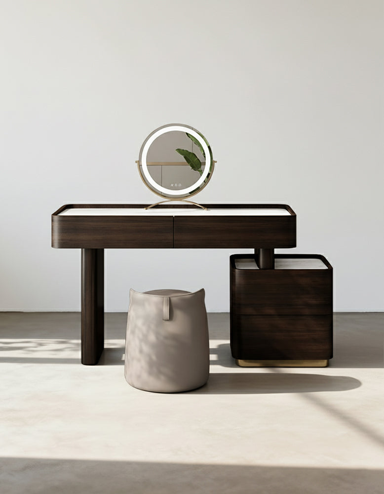 Modern dark wood console table with a round mirror and decorative items on a light background