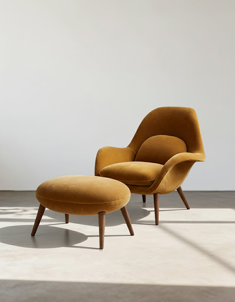 Mustard yellow armchair with matching ottoman on a light background