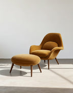 Mustard yellow armchair with matching ottoman on a light background