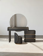 Modern vanity set with round mirror, stool, and boxes on a neutral background