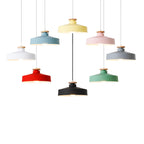 Colorful pendant lights hanging against a white background