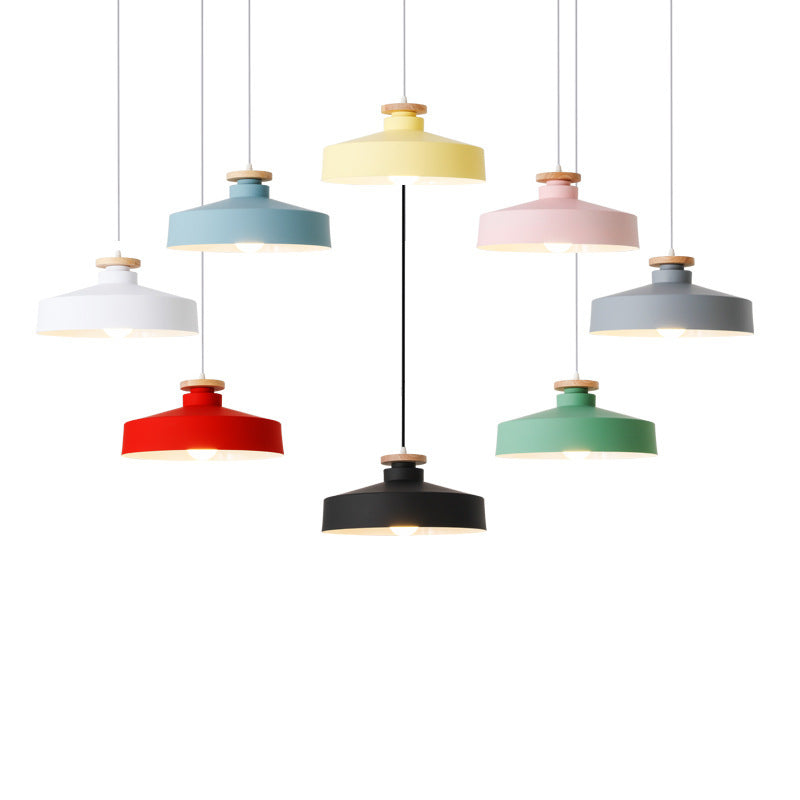 Colorful pendant lights hanging against a white background