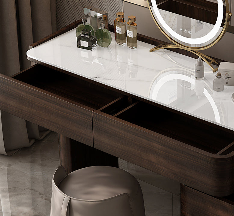 Bathroom vanity with marble countertop, mirror, and toiletries.
