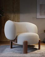 Modern beige armchair with wooden legs in a room setting