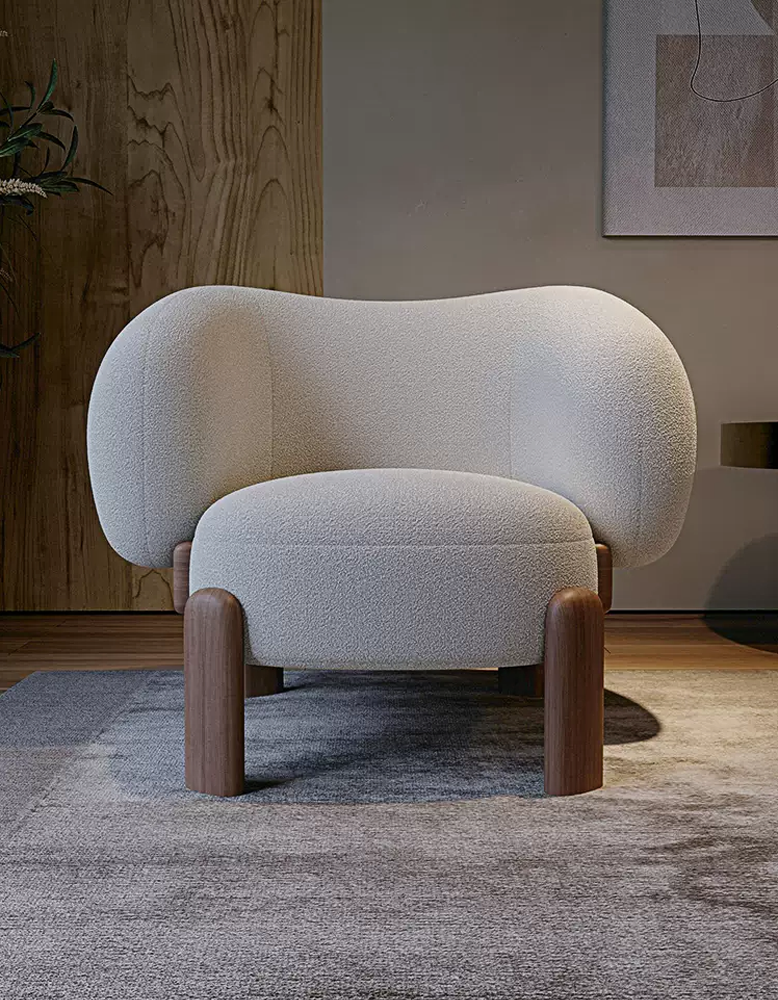Modern armchair with wooden legs in a room setting