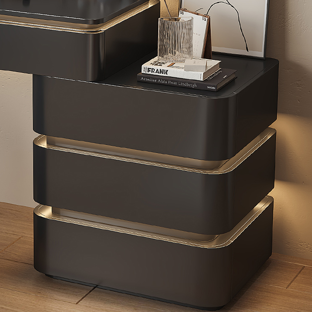 Black nightstand with gold accents on a wooden floor.