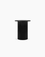 Black cylindrical side table on a white background