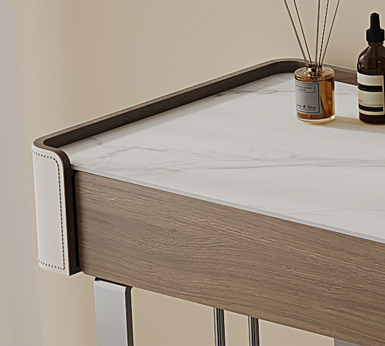 Wooden desk with marble top and decorative items on a neutral background
