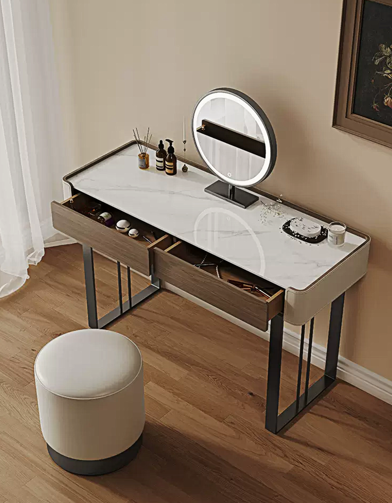 Dressing table with a round mirror and various items on a wooden floor.