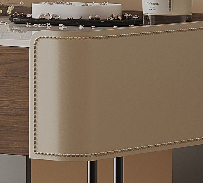 Close-up of a decorative table with a cake and bottle on a wooden surface.