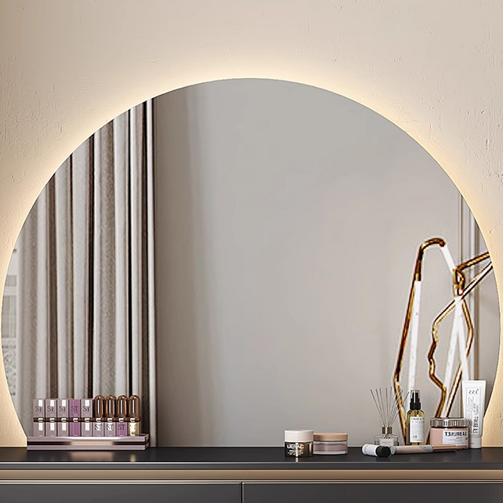 Round mirror with decorative items on a shelf against a neutral wall.