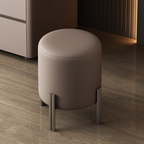 Round beige stool with metal legs on a wooden floor