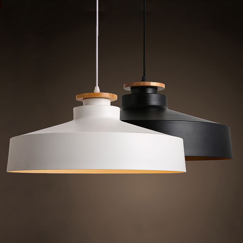 Two pendant lights, one white and one black, on a dark background