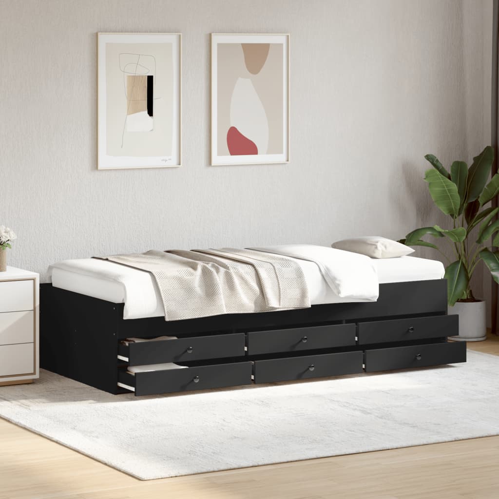 Black bed frame with storage drawers in a bedroom setting.