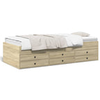 Wooden bed with white bedding and multiple drawers on a white background