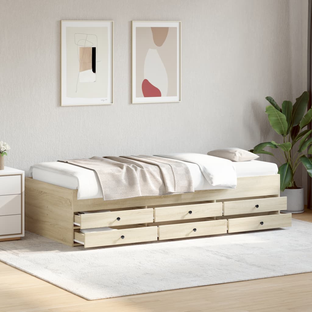 Wooden bed with drawers in a room with abstract art and a plant.