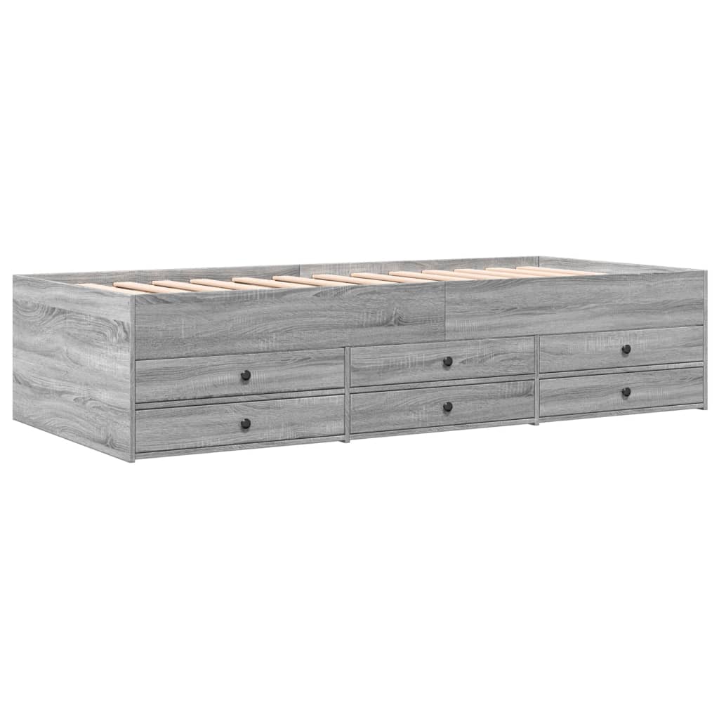 Gray wooden bed frame with multiple drawers on a white background