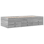 Gray wooden bed frame with multiple drawers on a white background