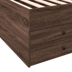 Wooden bed frame with drawers on a white background