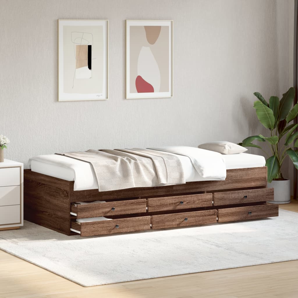 Wooden bed frame with storage drawers in a room with abstract art on the wall and a plant.