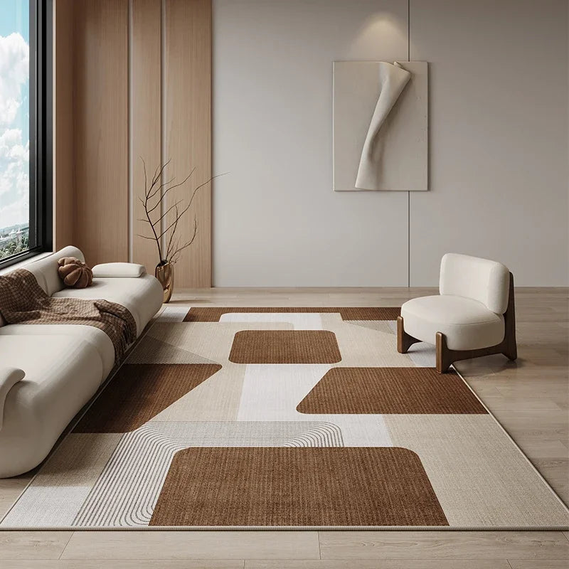 Modern living room with a geometric patterned rug, white sofa, and wooden armchair.