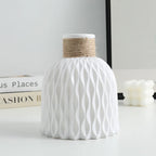 White textured vase with woven top on a light surface