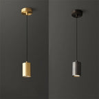 Two pendant lights, one gold and one silver, against a dark gray background.