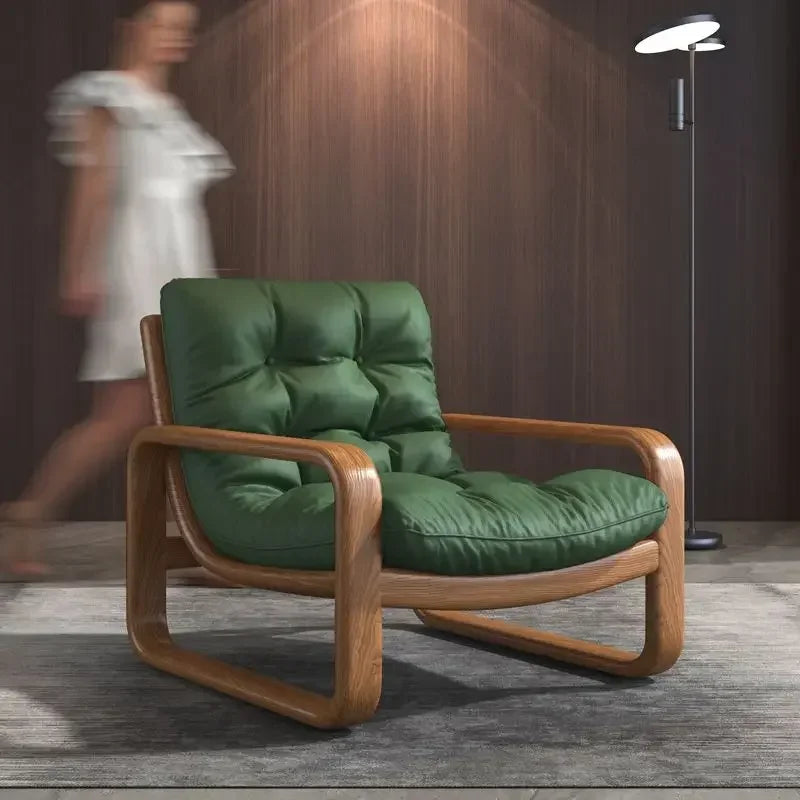 Green leather armchair with wooden frame in a room setting