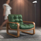 Green leather armchair with wooden frame in a room setting