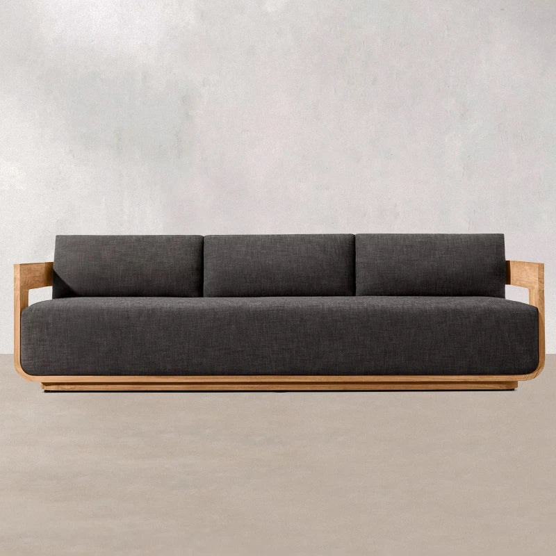 Gray sofa with wooden frame on a plain background