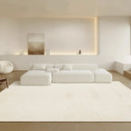 Modern living room with a white sectional sofa and rug.