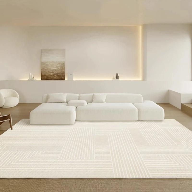 Modern living room with a white sectional sofa and rug.