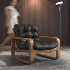 Black leather armchair with wooden frame in a room setting