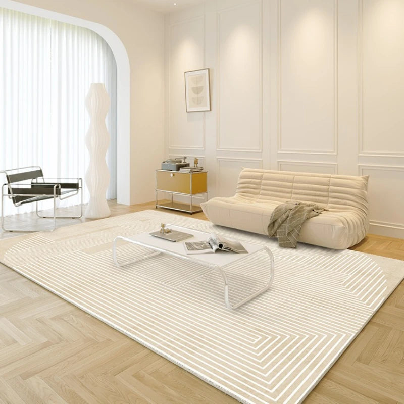 Modern living room with a beige sofa, glass coffee table, and white rug.