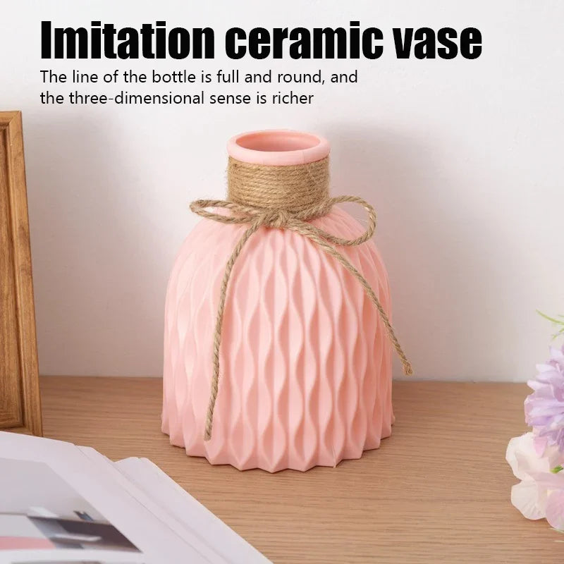 Pink ceramic vase with woven design on a wooden surface