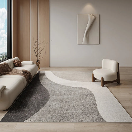 Modern living room with a gray and white area rug, white sofa, and white chair.