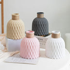 Set of decorative vases with textured surfaces on a light surface.