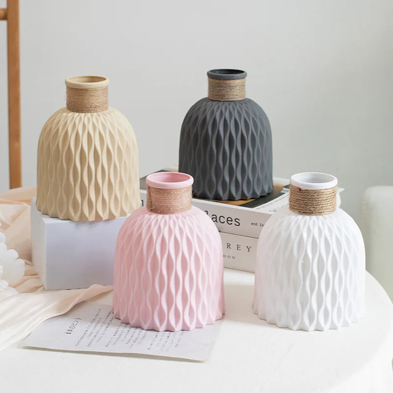 Set of decorative vases with textured surfaces on a light surface.