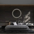 Modern bedroom with a bed, circular light fixture, and dark wood wall.