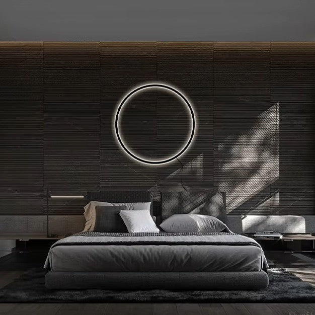 Modern bedroom with a bed, circular light fixture, and dark wood wall.
