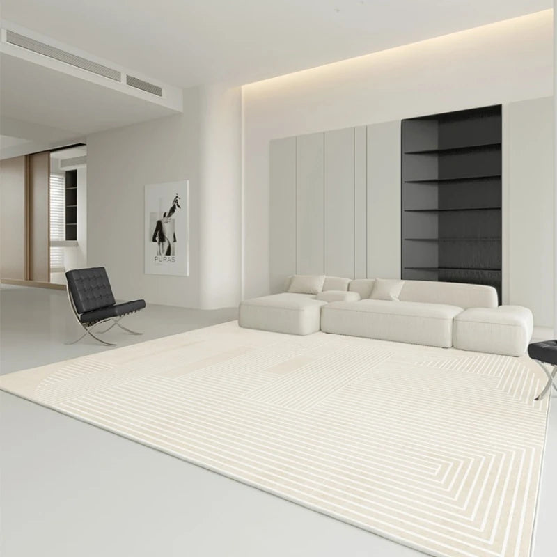 Modern living room with a white sofa, rug, and black chair.