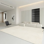 Modern living room with a white sofa, rug, and black chair.