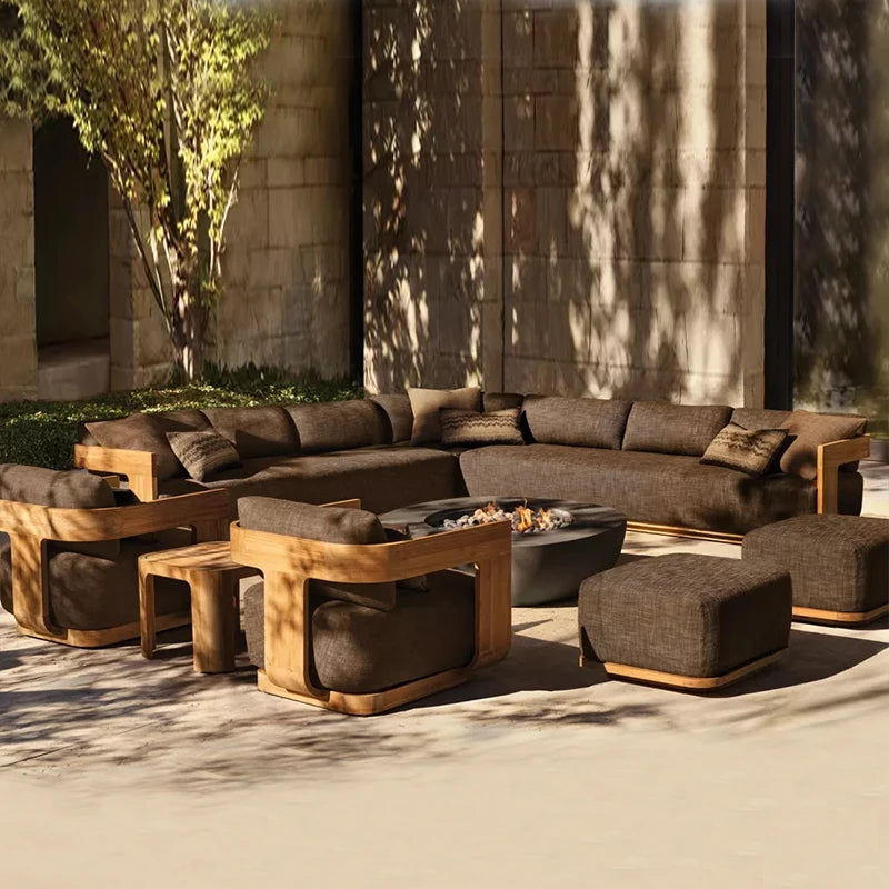 Outdoor patio furniture set with a fire pit table in a sunlit area.