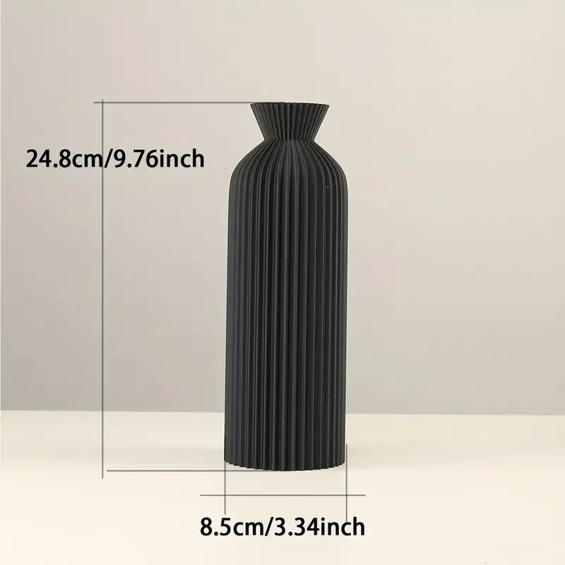 Black ribbed vase with measurements on a light gray background