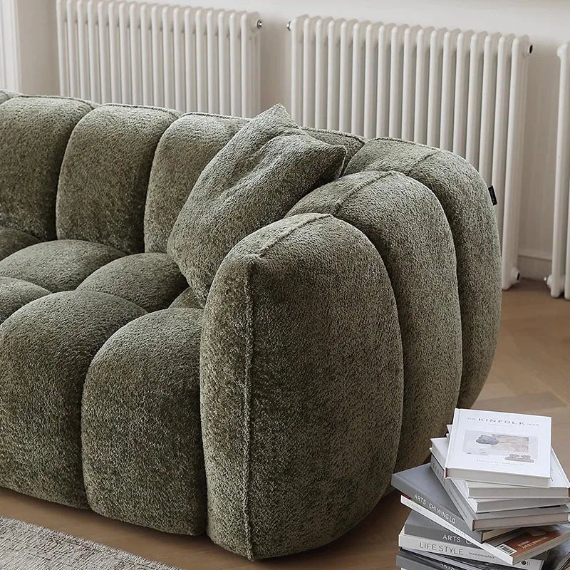 Green textured sofa in a room with white radiators.