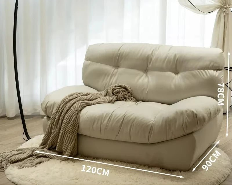 Beige sofa with dimensions labeled in a room with white curtains.