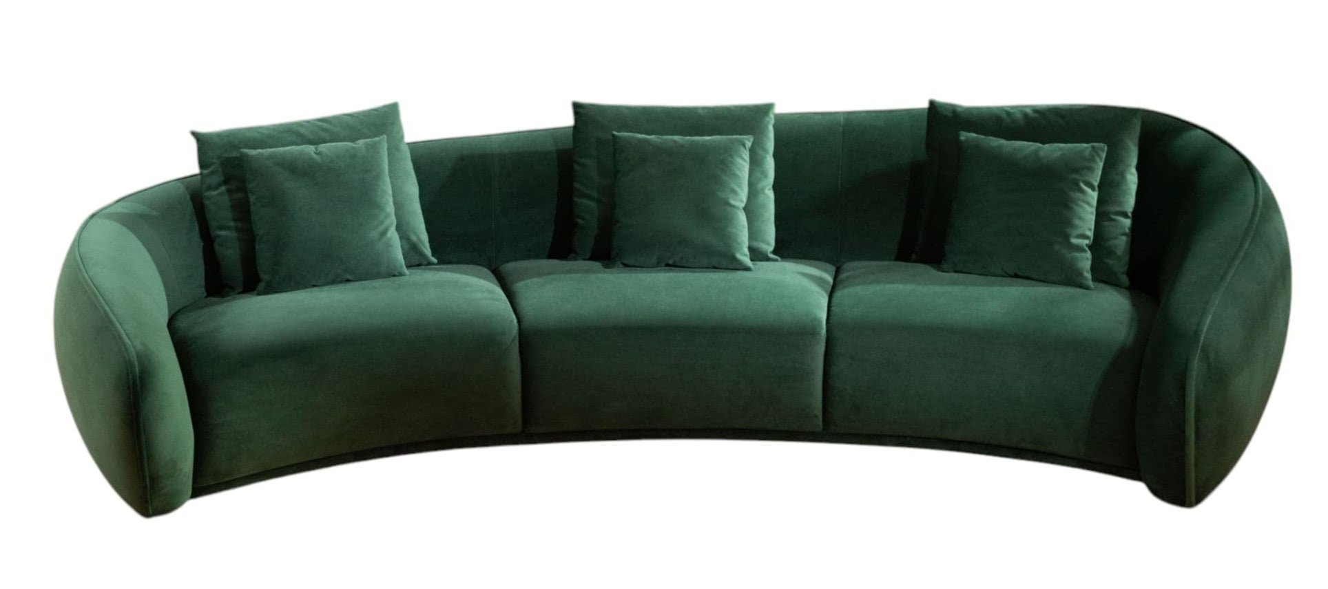 Green curved sofa with cushions on a white background
