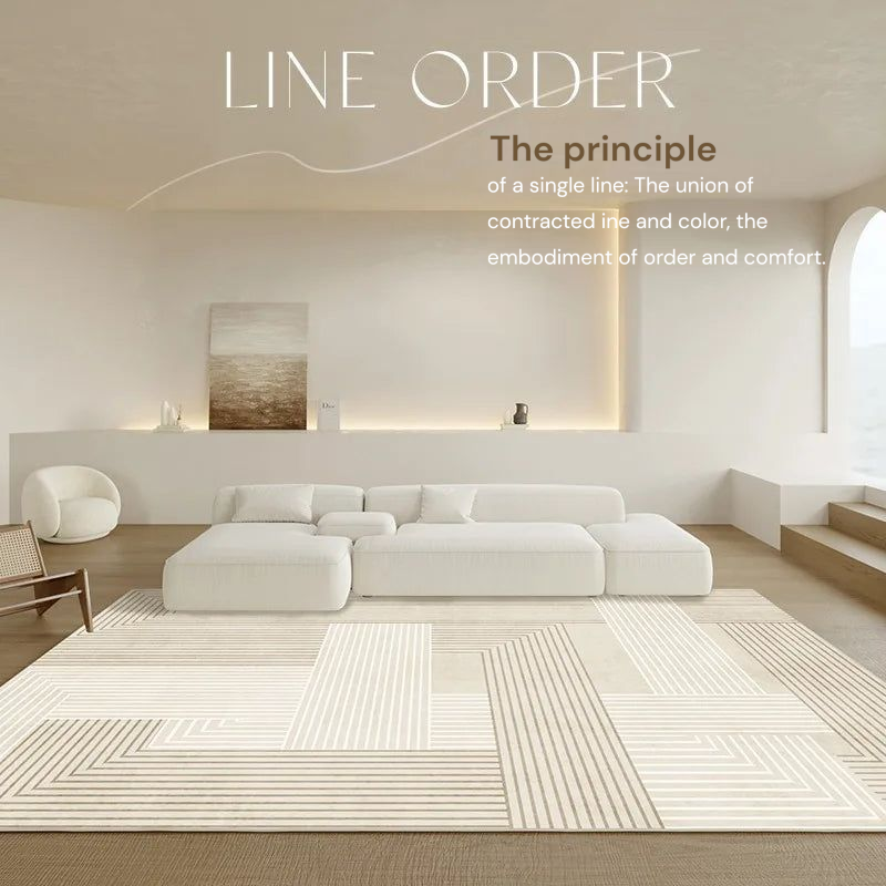 Modern living room with a white sofa, rug, and minimal decor.