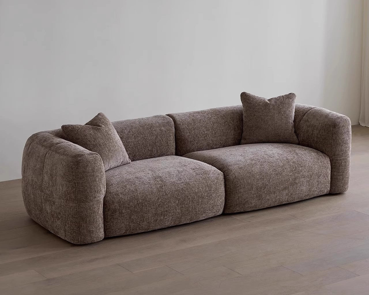 Brown sofa with cushions in a minimalistic room